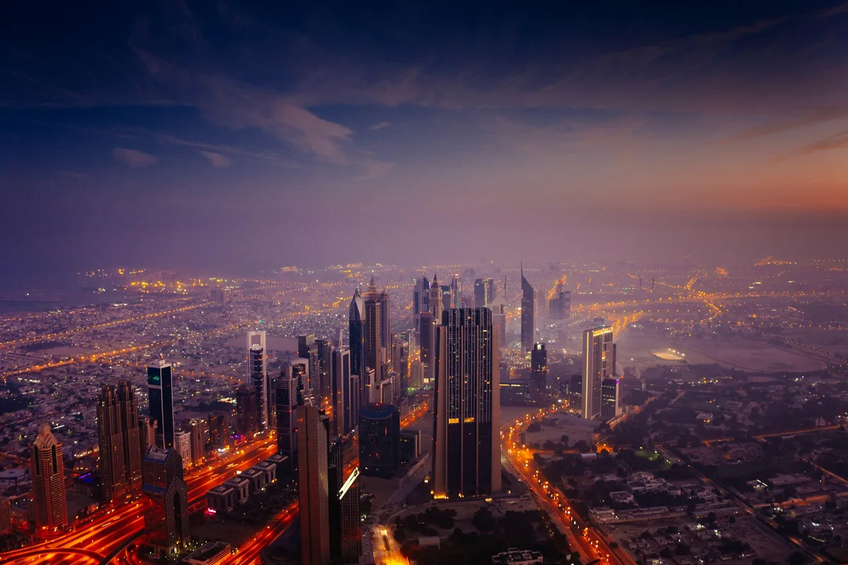 Dubai skyline and illuminated roads at sunrise